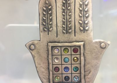 The symbolic 'HamSa', a palm-shaped amulet. This one contains 12 stones, representing the 12 tribes of Israel. (Photo: Gil Dekel, 2019).