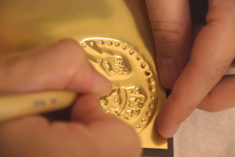 Figure 40: Embossing on metal sheets for the making of the Prince Coin, for The Prince of Hampshire (2006). Image © Gil Dekel.