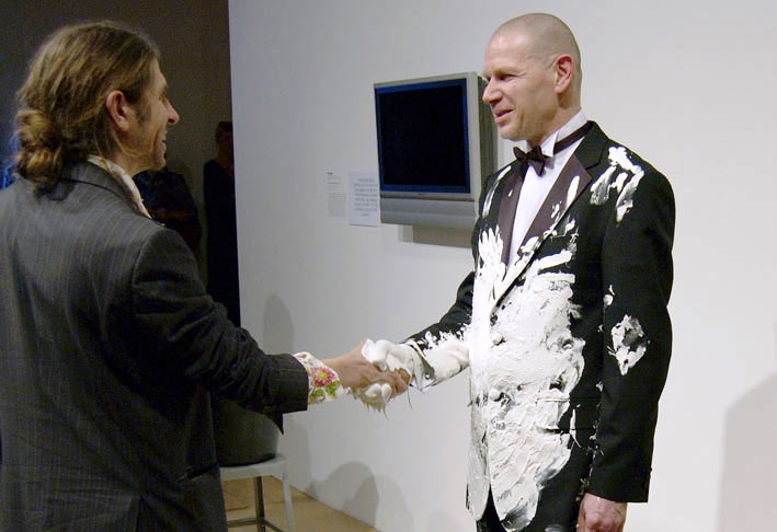 Figure 61: Roi Vaara (right), Wet Paint Handshakes (2008, performance in Hayward Gallery, London, black tuxedo, white paint). Photo: © Naranja. Image obtained from Roi Vaara. Permission to use image obtained from Roi Vaara.